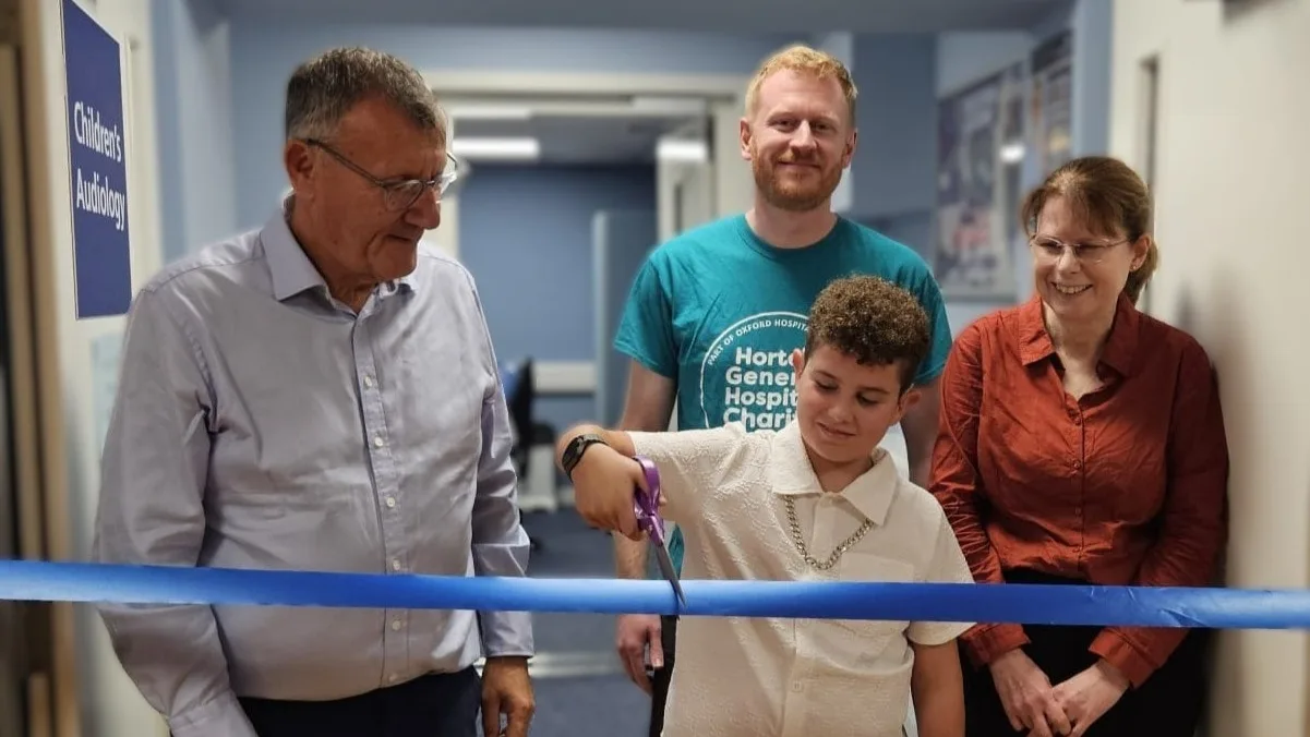 Antony cuts the ribbon at the Children's Audiology unit, with Sir Andrew Morris, Jamie French and his mother Mary