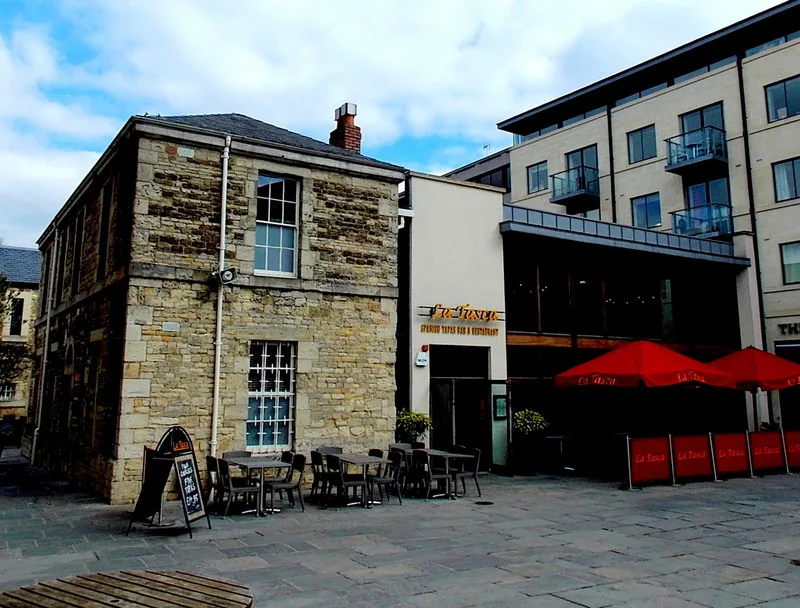 Building 5 at the Oxford Castle Quarter in 2013: the stone Warden's House on the left and the 2000s extension that La Tasca traded from until 2016